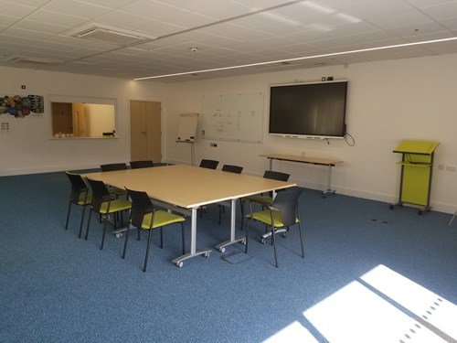 Meeting room with table and chairs and TV
